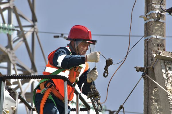 A worker carrying out exterior CCTV maintenance