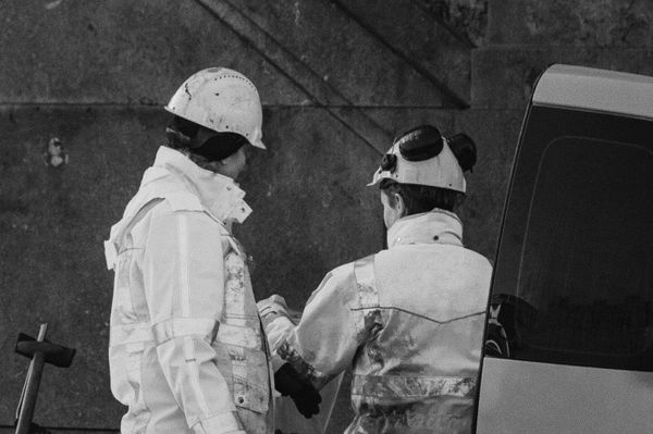 Two idustrial workers talking on site